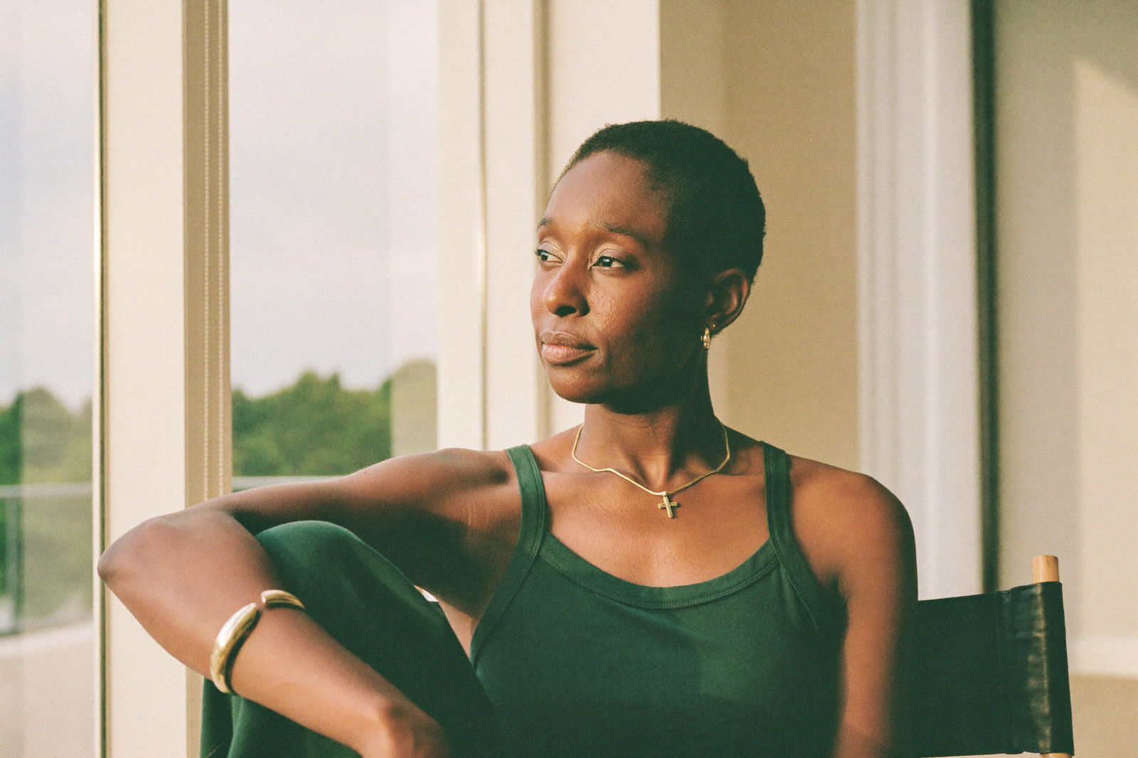 A woman at a bright window, considering the years ahead